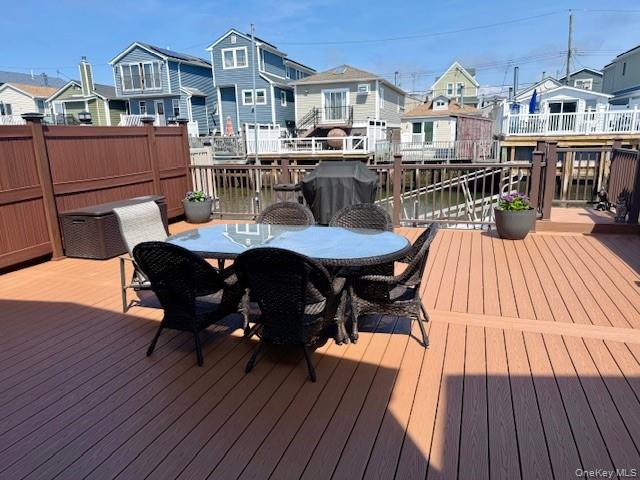 19 West 13th Road Queens, NY 11693 - Photo 14 of 20 a view of a deck with table and chairs with wooden floor