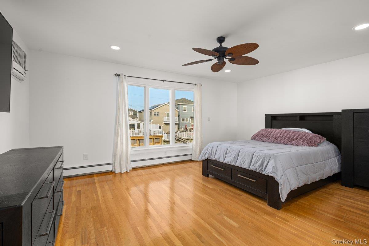 19 West 13th Road Queens, NY 11693 - Photo 8 of 19 a spacious bedroom with a bed and dresser