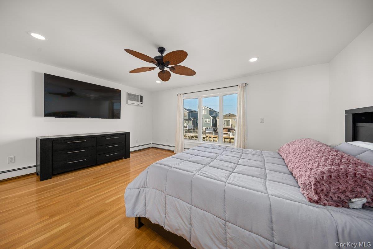 19 West 13th Road Queens, NY 11693 - Photo 9 of 19 a bedroom with a bed and a flat screen tv