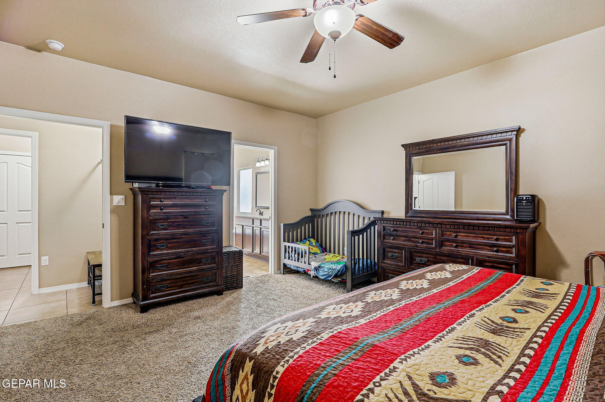 612 Bell Gordon Street Anthony, TX 79821 - Photo 18 of 64 a bedroom with a bed and a chandelier