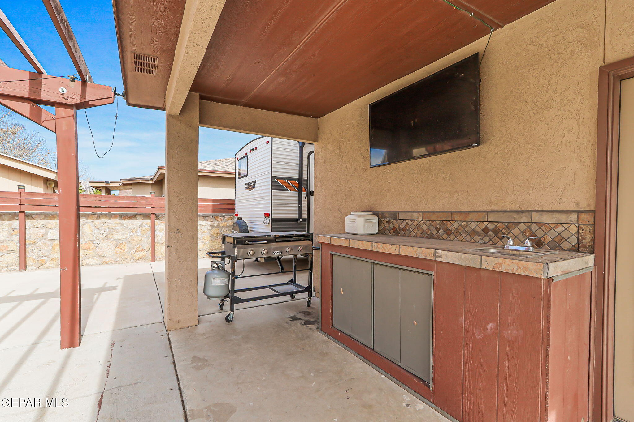 612 Bell Gordon Street Anthony, TX 79821 - Photo 34 of 64 a view of kitchen living room with a flat screen tv and floor to ceiling window