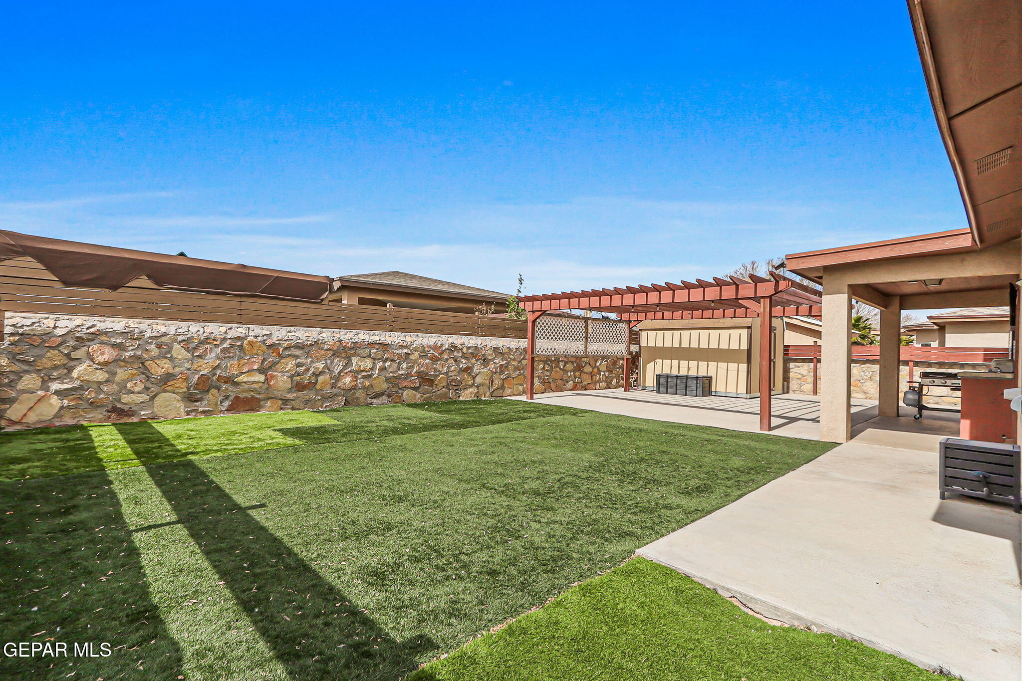 612 Bell Gordon Street Anthony, TX 79821 - Photo 39 of 64 a view of a backyard with lawn chairs and iron fence