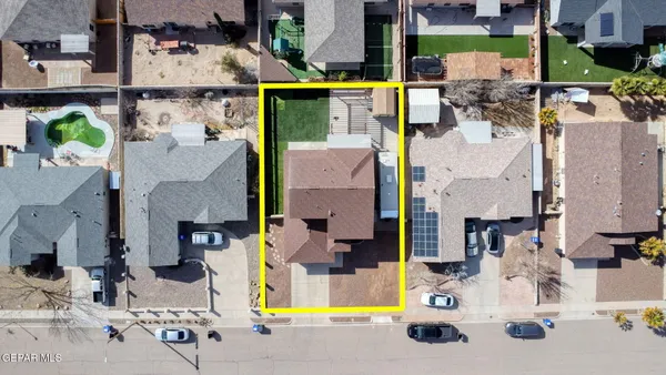 an aerial view of a house with a mountain