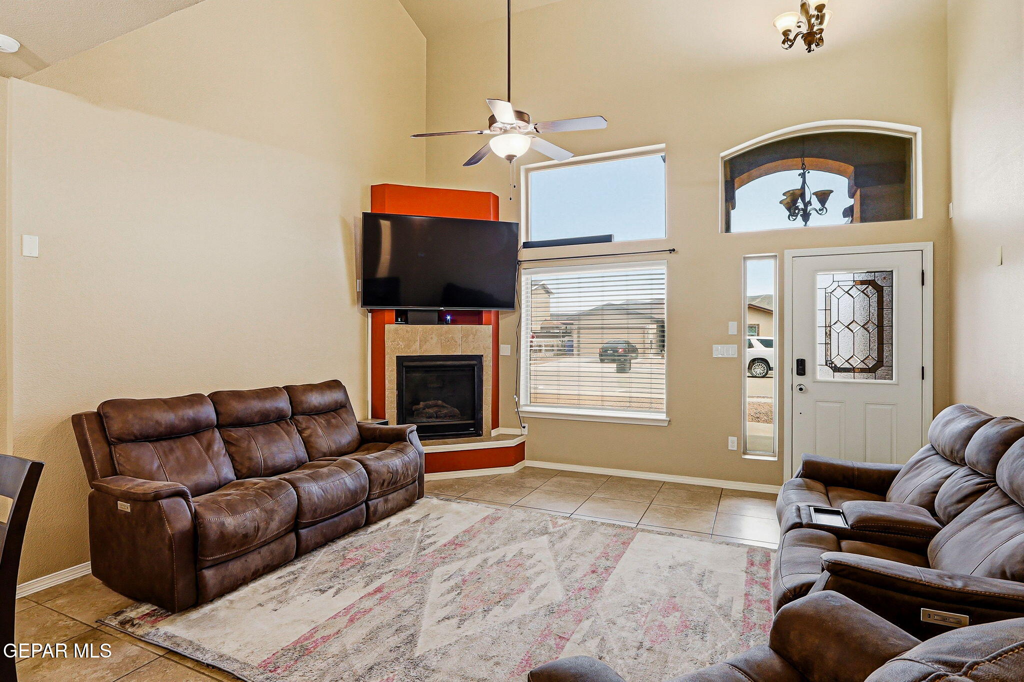 612 Bell Gordon Street Anthony, TX 79821 - Photo 9 of 64 a living room with furniture a flat screen tv and a fireplace