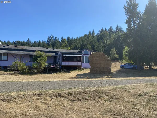 a view of a house with a yard covered with snow in the background