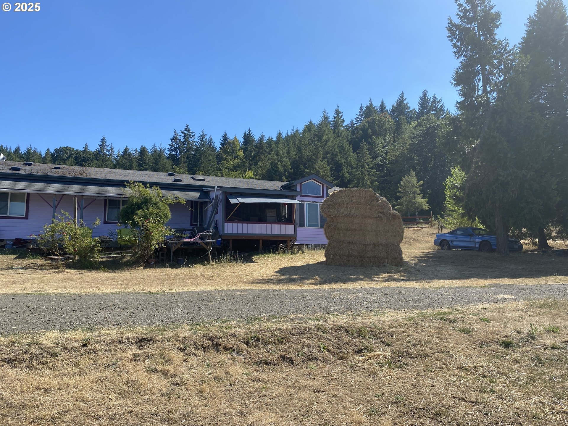 7555 Sawtell Road Sheridan, OR 97378 - Photo 2 of 31 a view of a house with a yard covered with snow in the background