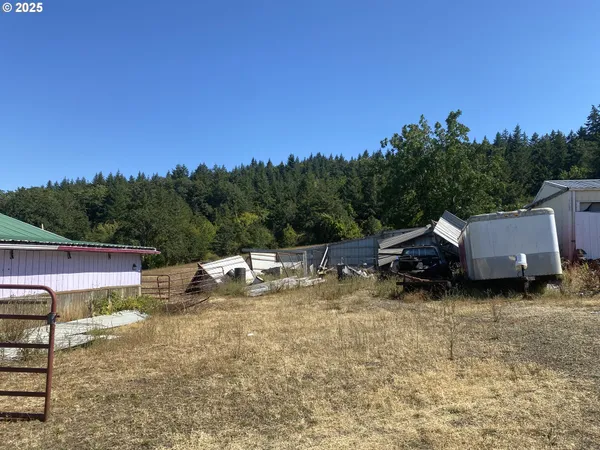 a view of a house with yard and sitting area