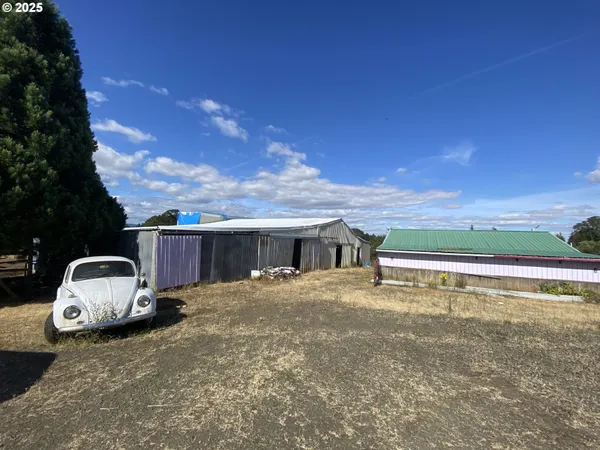 a view of a house with pool and a yard