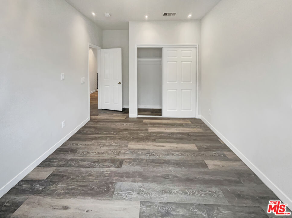125 Lakeside Drive Buena Park, CA 90621 - Photo 13 of 57 a view of an empty room with wooden floor