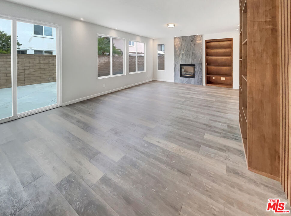 125 Lakeside Drive Buena Park, CA 90621 - Photo 26 of 57 a view of a big room with wooden floor and windows