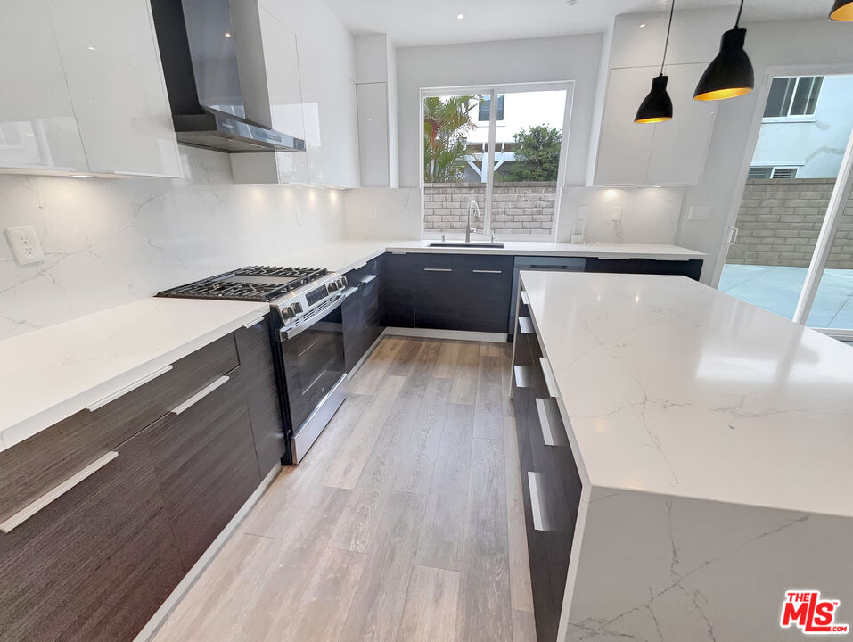125 Lakeside Drive Buena Park, CA 90621 - Photo 29 of 57 a kitchen with wooden floor and a sink