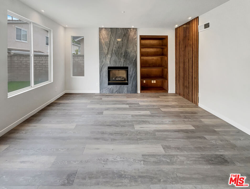 125 Lakeside Drive Buena Park, CA 90621 - Photo 3 of 57 a view of an empty room with a fireplace and a window