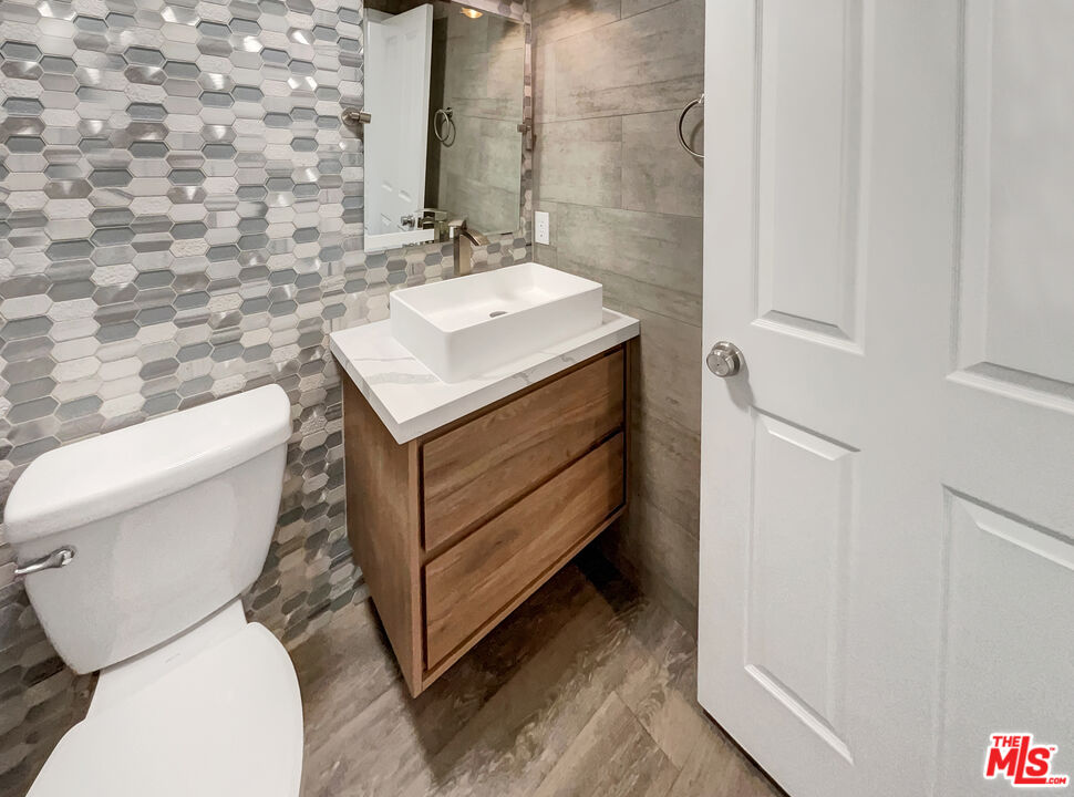 125 Lakeside Drive Buena Park, CA 90621 - Photo 32 of 57 a bathroom with a toilet sink and mirror