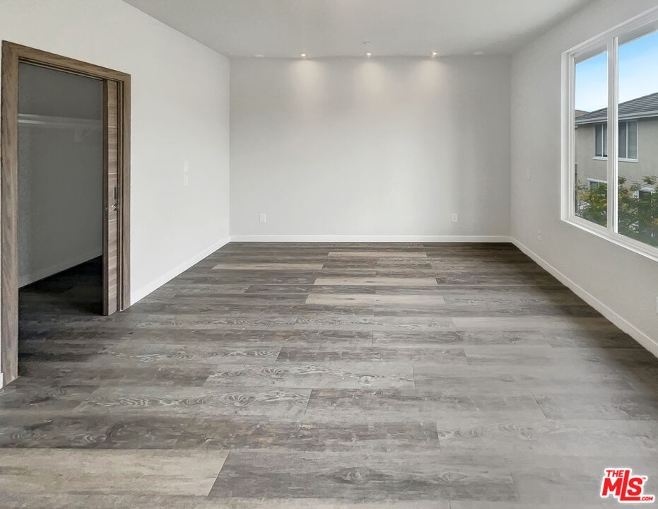 125 Lakeside Drive Buena Park, CA 90621 - Photo 36 of 57 a view of empty room with wooden floor and fan