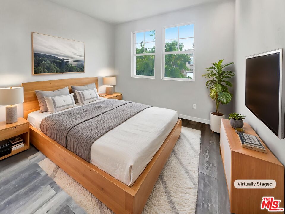 125 Lakeside Drive Buena Park, CA 90621 - Photo 4 of 57 a bedroom with a bed table flat screen tv and a window