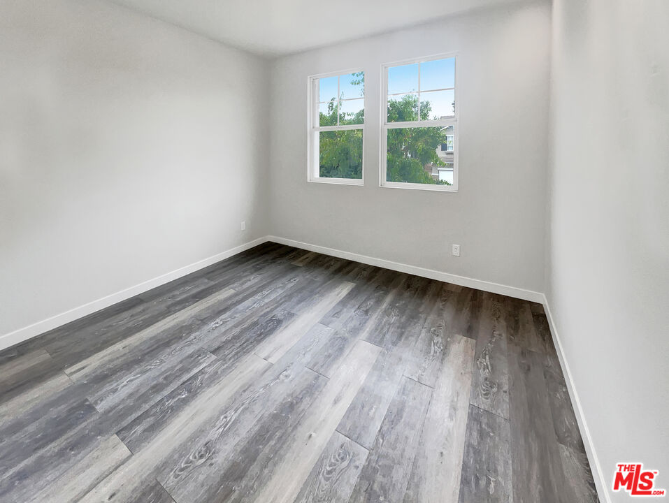 125 Lakeside Drive Buena Park, CA 90621 - Photo 5 of 57 an empty room with wooden floor and windows