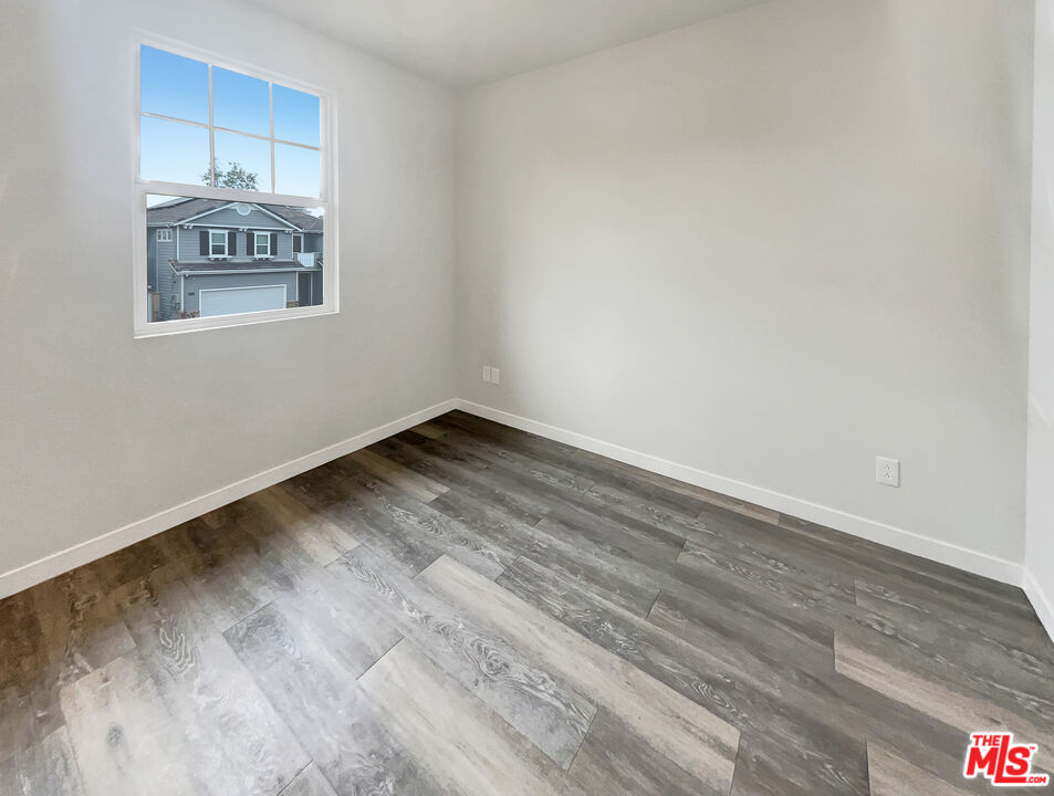 125 Lakeside Drive Buena Park, CA 90621 - Photo 52 of 57 a view of a room with wooden floor and white walls