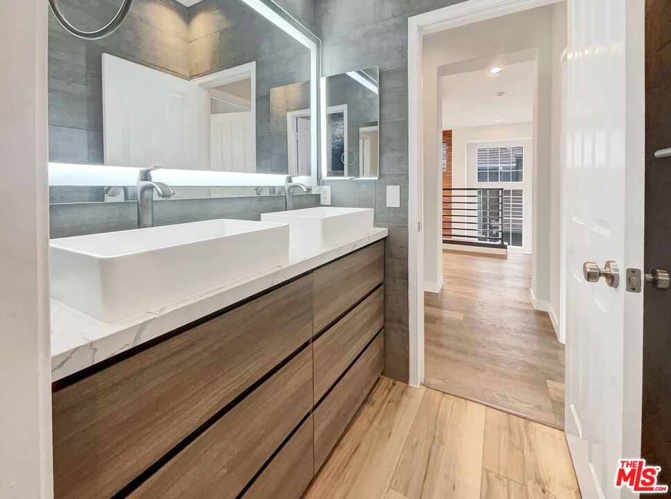 125 Lakeside Drive Buena Park, CA 90621 - Photo 56 of 57 a bathroom with a sink and a mirror