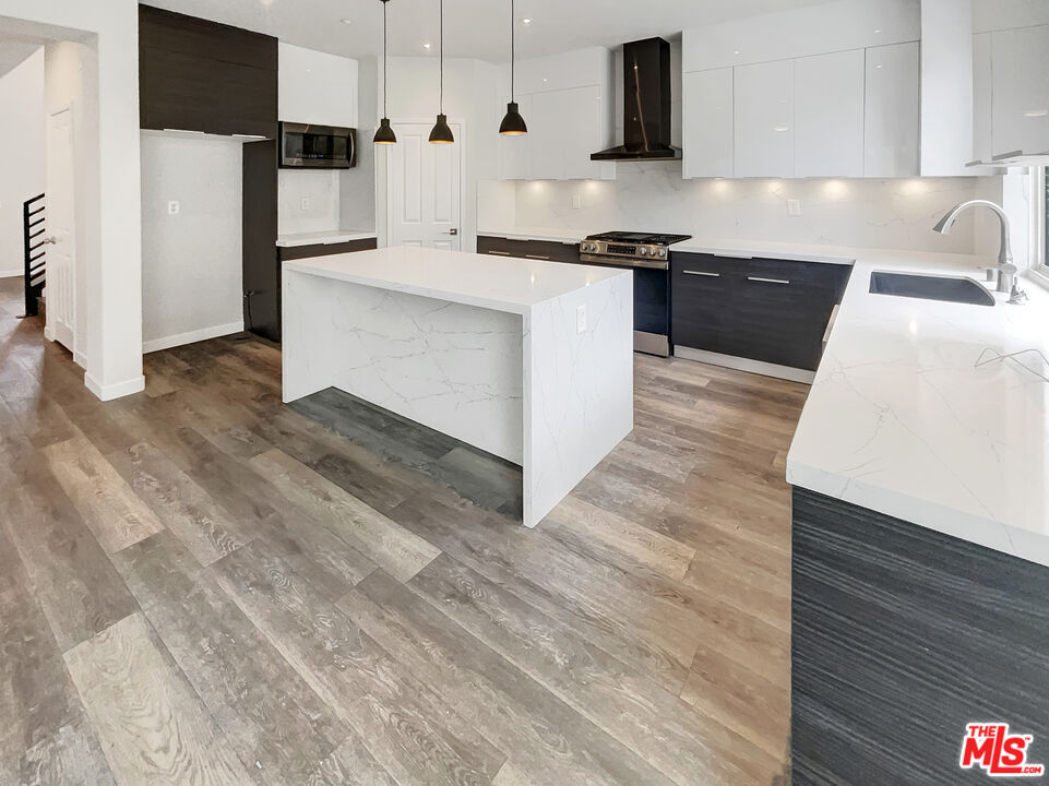 125 Lakeside Drive Buena Park, CA 90621 - Photo 6 of 57 a kitchen with stainless steel appliances granite countertop a sink stove and refrigerator