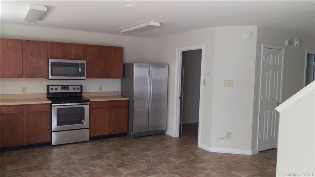 8804 Old Potters Road Charlotte, NC 28269 - Photo 5 of 12 a kitchen with stainless steel appliances granite countertop a refrigerator stove and sink