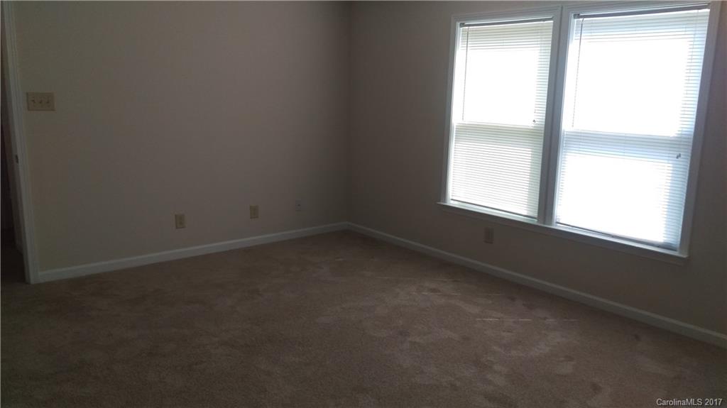 8804 Old Potters Road Charlotte, NC 28269 - Photo 8 of 12 an empty room with a window