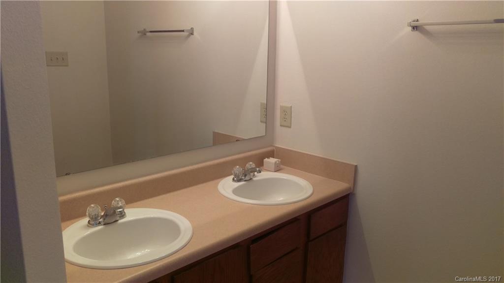 8804 Old Potters Road Charlotte, NC 28269 - Photo 9 of 12 a bathroom with a sink and a mirror