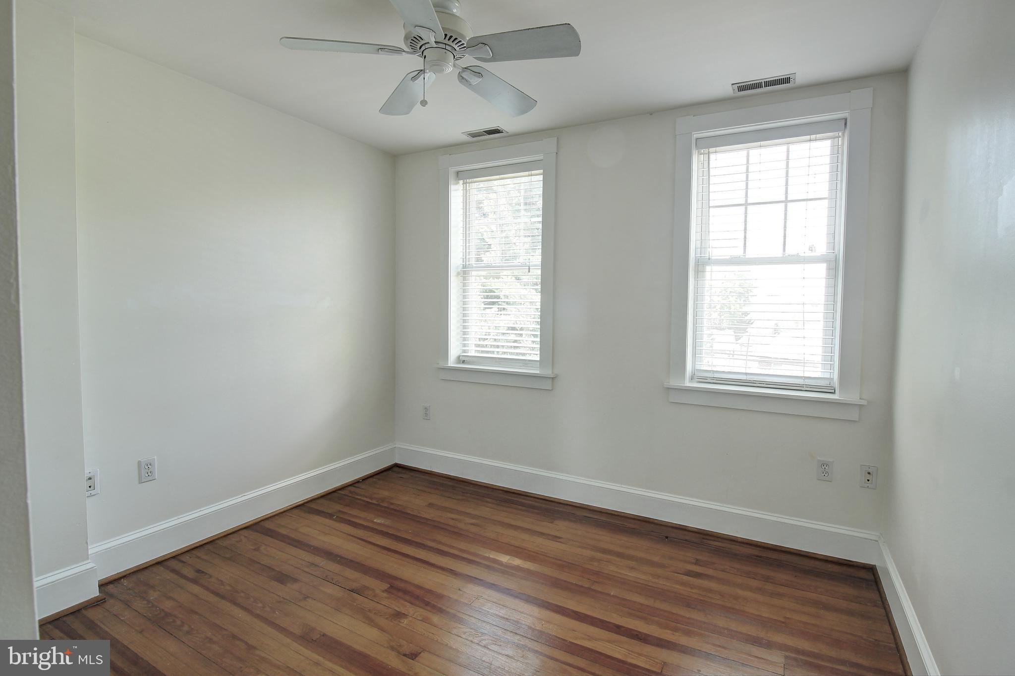 206 East 8th Street, Unit 2 Frederick, MD 21701 - Photo 7 of 10 a view of an empty room with wooden floor and a window