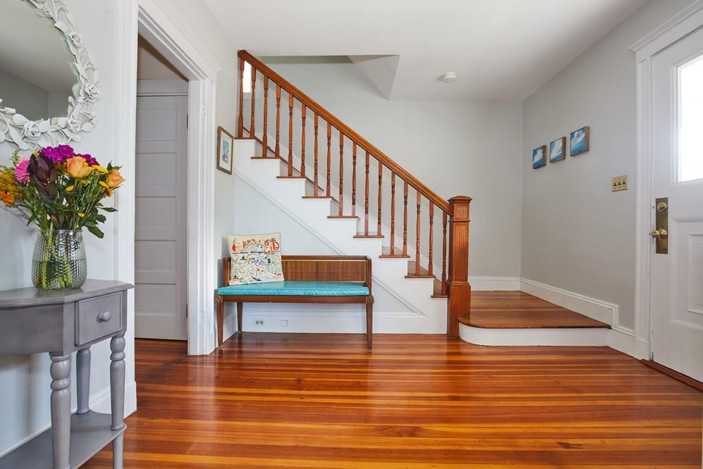 a view of entryway and hall with wooden floor