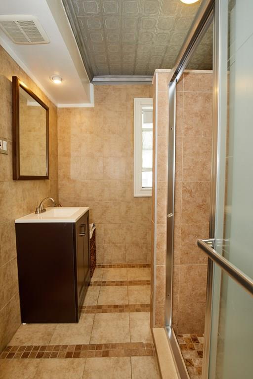 202 Metropolitan Avenue Boston, MA 02131 - Photo 21 of 31 a bathroom with a sink mirror and shower