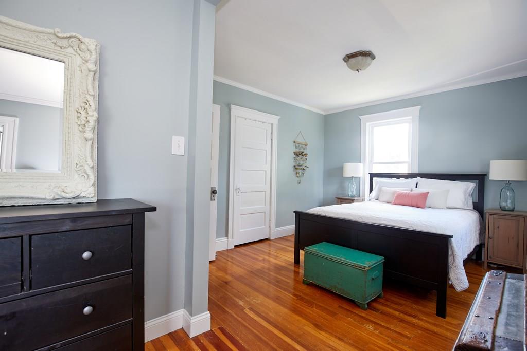202 Metropolitan Avenue Boston, MA 02131 - Photo 24 of 31 a bedroom with a bed and a dresser