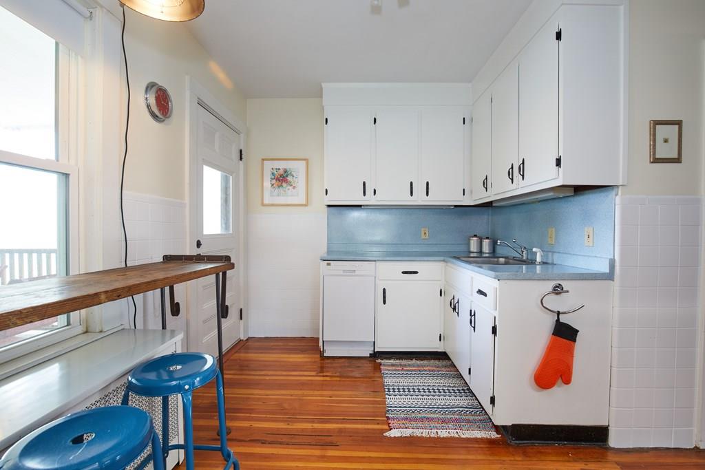 202 Metropolitan Avenue Boston, MA 02131 - Photo 7 of 31 a kitchen with granite countertop white cabinets and sink