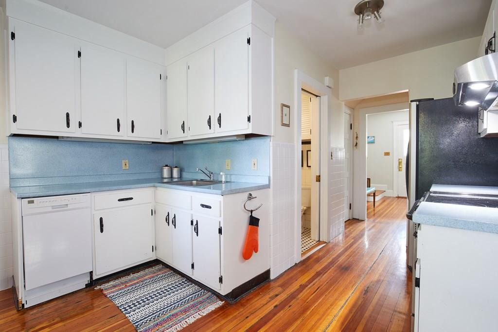 202 Metropolitan Avenue Boston, MA 02131 - Photo 8 of 31 a kitchen with stainless steel appliances granite countertop a refrigerator sink and white cabinets