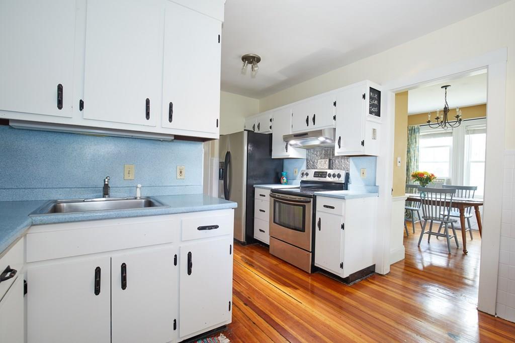 202 Metropolitan Avenue Boston, MA 02131 - Photo 9 of 31 a kitchen with white cabinets and white appliances