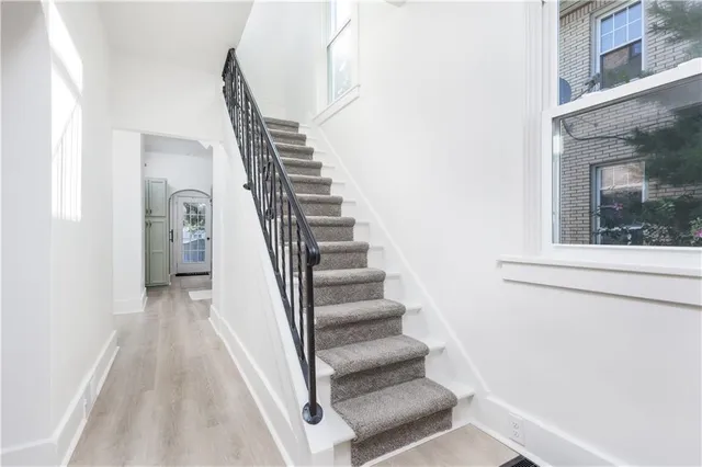 a view of an entryway with wooden floor