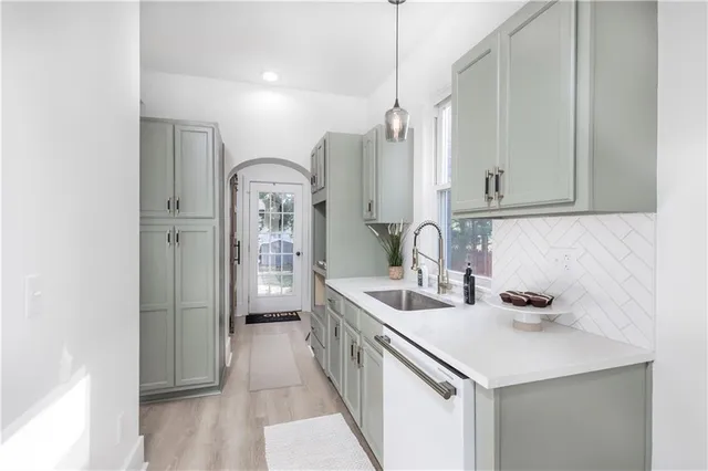 a kitchen with white cabinets and stainless steel appliances