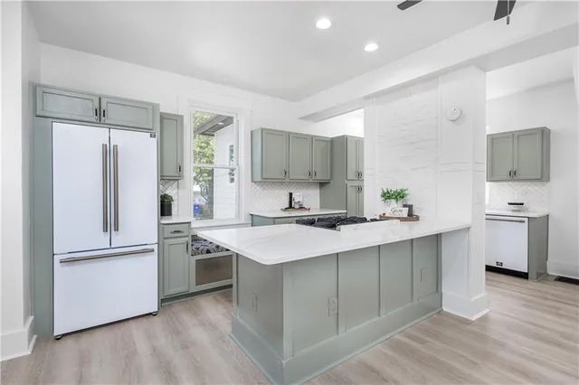 a kitchen with a stove a sink and a window