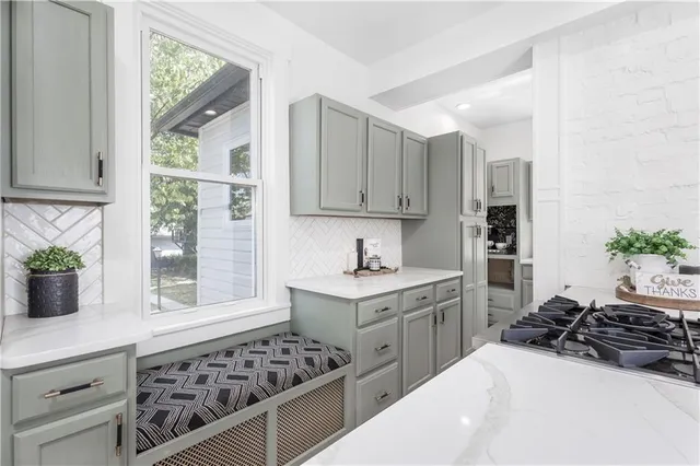 a kitchen with a sink cabinets and wooden floor