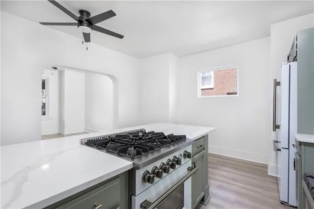 a view of kitchen and hall with wooden floor