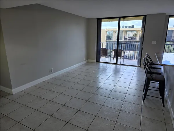 a kitchen with a granite countertop sink a rug and a large window