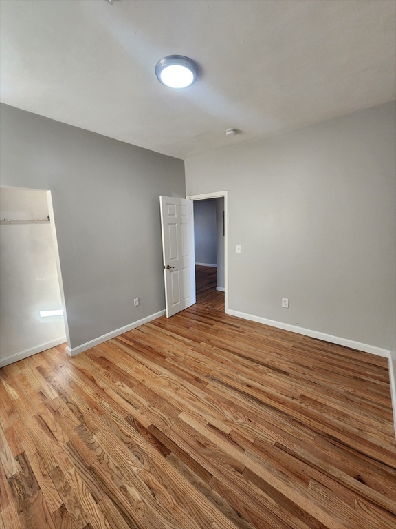 920 Pine Street, Unit 3W Fall River, MA 02720 - Photo 7 of 9 a view of an empty room with wooden floor and closet