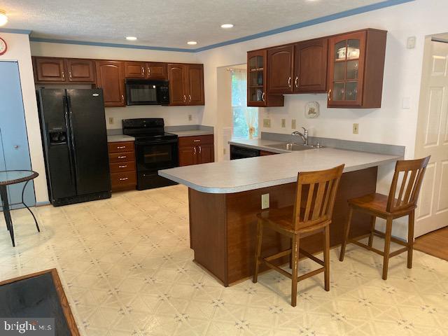 1718 Ballenger Creek Point Point of Rocks, MD 21777 - Photo 13 of 45 a kitchen with stainless steel appliances kitchen island granite countertop a refrigerator and a stove top oven