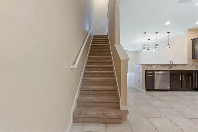 a view of a kitchen with stairs and a sink