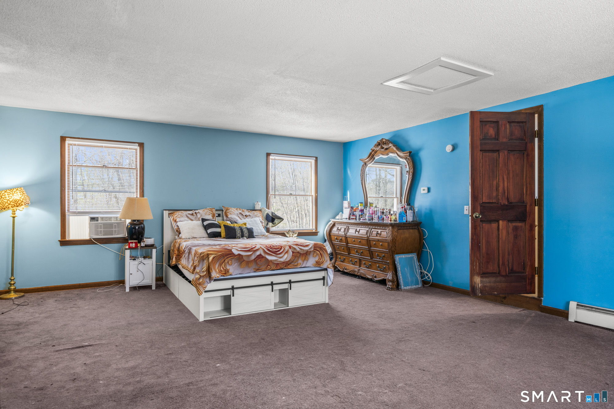 184 Black Hill Road Plainfield, CT 06374 - Photo 18 of 39 a bedroom with a bed and a chandelier