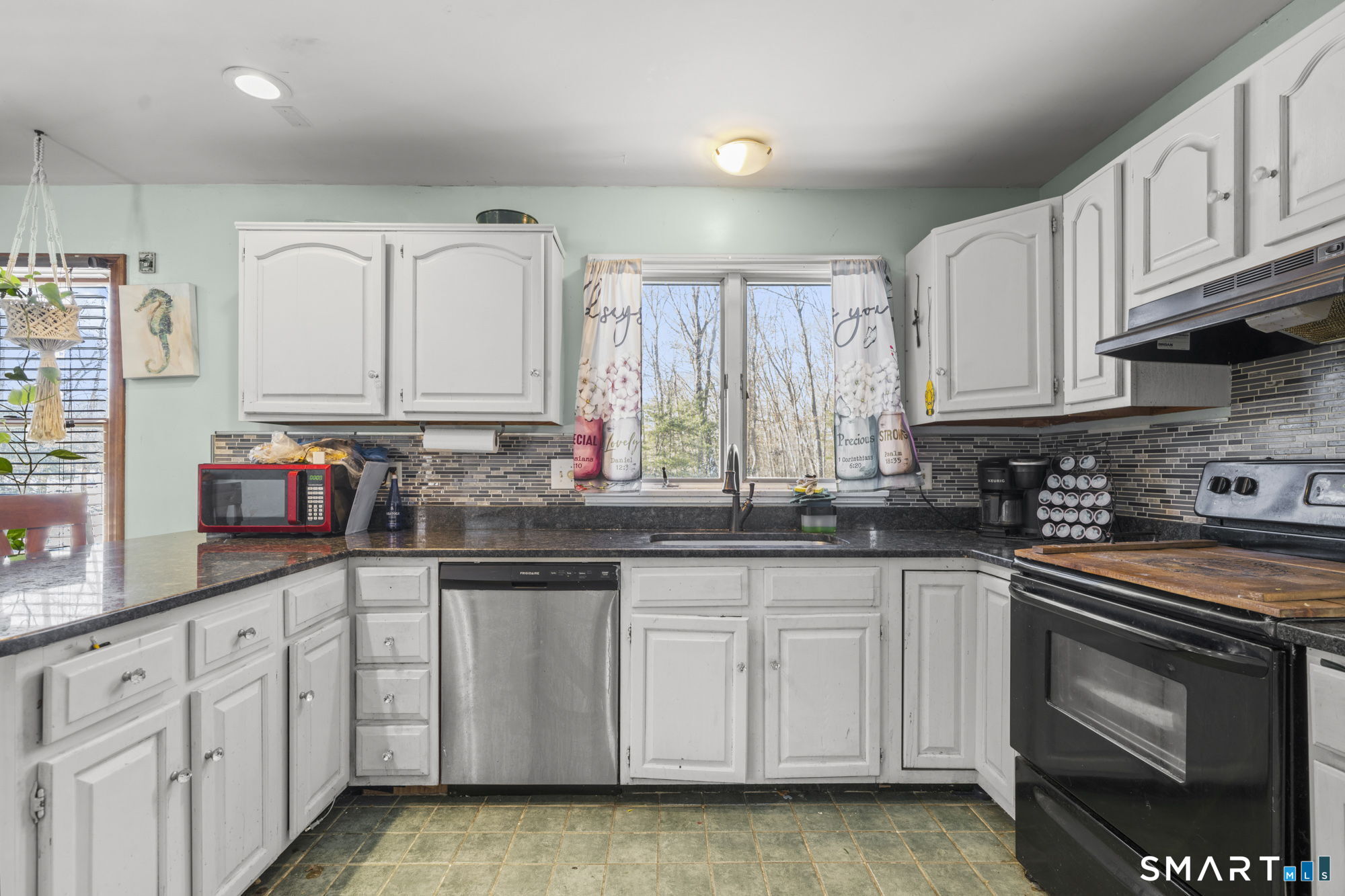 184 Black Hill Road Plainfield, CT 06374 - Photo 5 of 39 a kitchen with granite countertop a sink stove and cabinets