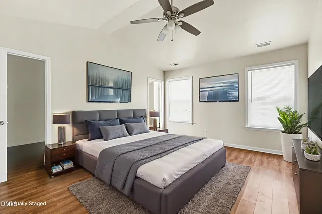 a bedroom with bed and painting on the wall