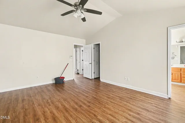 a view of a room with wooden floor and white walls