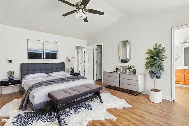 a bedroom with a bed and wooden floor