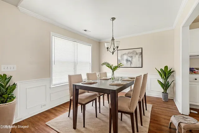 a view of a dining room with furniture window and wooden floor