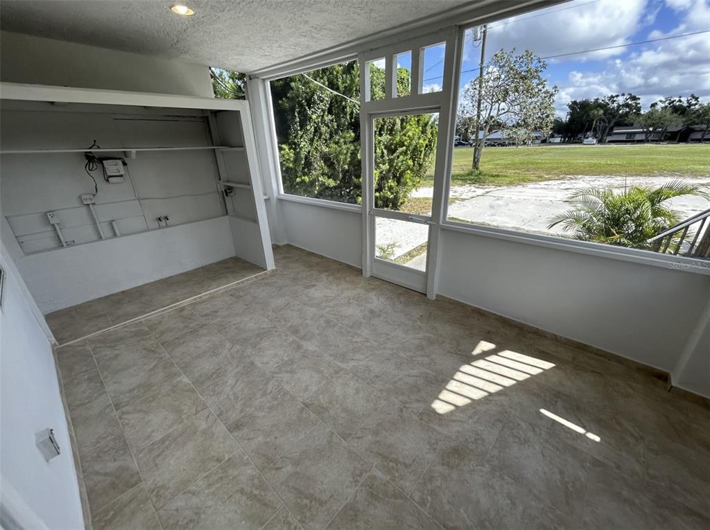 620 5th Avenue West, Unit A DOWNSTAIRS Palmetto, FL 34221 - Photo 11 of 13 a view of an empty room with a fireplace and a floor to ceiling window