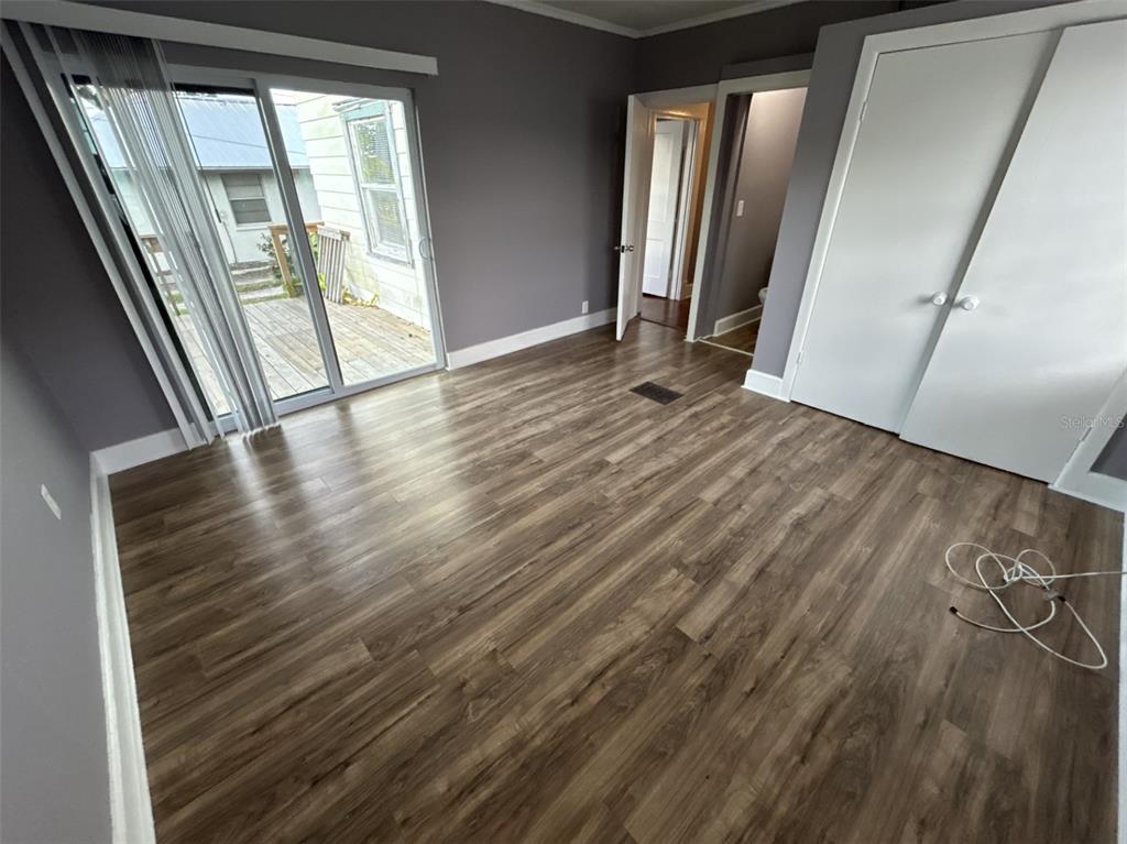 620 5th Avenue West, Unit A DOWNSTAIRS Palmetto, FL 34221 - Photo 2 of 13 a view of an empty room with wooden floor and a window
